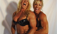 Lauren teams up with Gayle for a photo-shoot. Lauren gets so excited she can hardly stay in her much-too-small bikini. The two blonde amazons pose for the camera, then hug, squeeze and caress each other's muscles. Both of them seem to be enjoying this immensely. 
